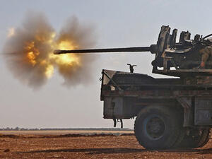 Fighters from the Free Syrian Army fire an anti-aircraft machine gun mounted on a vehicle deploy during fighting against the Islamic State (IS) group jihadists in the northern Syrian village of Yahmoul. (AFP/File)