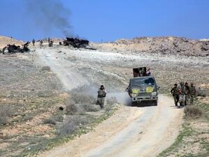 Syrian pro-government forces advance on a road through the town of Khanasser, the sole link between government-held areas in and around Aleppo and the rest of the country, after recapturing it from Daesh, on February 29, 2016. (AFP/Georges Ourfalian)