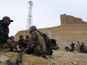 Syrian pro-government forces rest next to the Palmyra citadel on March 26, 2016, during a military operation to retake the ancient city from Daesh.  (AFP/Maher al-Mounes)
