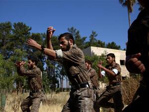 Rebel fighters who recently joined the Failaq al-Rahman brigade take part in a training session at a camp in Syria's rebel-held Eastern Ghouta region before being sent to the front lines, on July 11, 2015. (AFP/File)