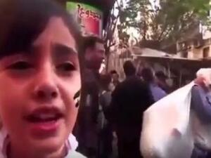 صورة ماخوذة من الفيديو للطفلة وهي تغني قبل انفجار القذيفة وراءها