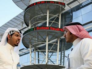 Saudi men chat outside the Saudi Stock Exchange in Riyadh. (AFP/ File)