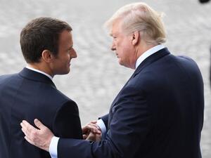 French President Emmanuel Macron (L) bids farewell to his US counterpart Donald Trump (AFP/File Photo)