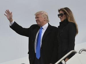 US President Donald Trump and his wife Melania step off a plane upon arrival at Andrews Air Force Base in Maryland on January 19, 2017. (AFP/ Mandel Ngan)