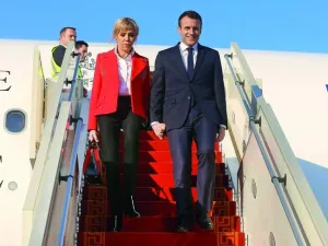French President Emmanuel Macron and his wife Brigitte Macron descend from an airplane upon their arrival at Tunis-Carthage International Airport on January 31, 2018. (Zoubeir Souissi/ AFP)