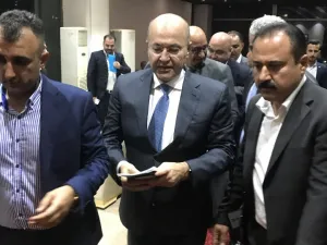 Newly elected Iraqi President Kurdish Barham Saleh (C) walks at the parliament in Baghdad on October 2, 2018. Karim AMMAR / AFP