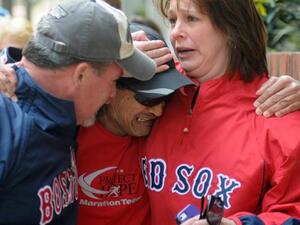 Runner crying when he finds friends after two explosions at the Boston Marathon finish line (AFP/ John Mottern)