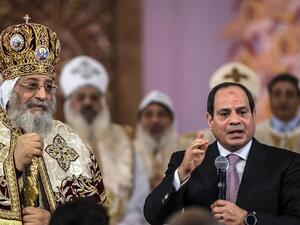 Egyptian president Abdel Fattah El Sisi speaks during a Christmas Eve mass as Coptic Pope Tawadros II looks on at the new Nativity of Christ Cathedral. (Khaled Desouki / AFP)

