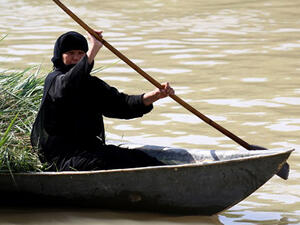 An Iraqi woman rides a boat in the Ahwar area in the southern Maysan province -- also known as the Iraqi Marshlands -- one of the world's largest inland delta systems. (AFP/File)