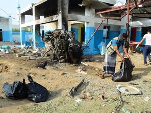 Workers clear rubble from the destroyed MSF hospital in Yemen on August 18. (AFP/File)