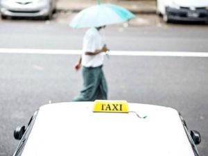 A man walks past a parked taxi (AFP/File Photo)