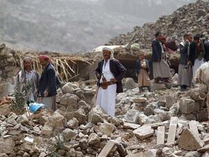 Yemeni civilians look through the rubble of their homes after an airstrike west of the capital in 2015. (AFP/File)