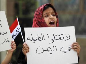 A Yemeni girl holds a placard during a protest in the capital Sanaa against the Saudi-led military operations, on June 6, 2015. The placard reads in Arabic: "Don't kill childhood in Yemen". (AFP/Mohammed Huwais)