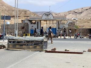 Yemeni police stand outside a public security office after a suicide bombing in Mukalla. (AFP/Stringer)