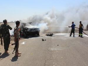 Yemeni security forces extinguish fire at a site where a bomb-laden car exploded in Aden's Mansura district on May 1, 2016. (AFP/Saleh al-Obeidi)