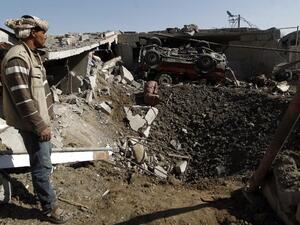 Yemenis check the destruction following a reported airstrike by Saudi-led coalition airplanes in the capital Sanaa on September 4, 2016. (AFP/Mohammed Huwais)