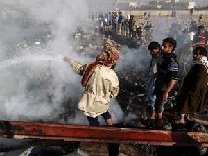 Yemenis inspect the damage at a sewing workshop that was hit by a Saudi-led coalition air strike in the capital Sanaa, on February 14, 2016. (AFP/Mohammed Huwais)