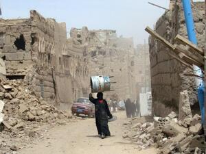 A Yemeni woman walks through a heavily damaged neighborhood in the war-battered city of Saada, March 8, 2015. (AFP/File)