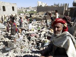 A Yemeni man sits on the rubble as people search for survivors in houses destroyed by a Saudi-led air strike on Yemen’s capital, Sanaa, on May 1, 2015. (Mohammed Huwais/ AFP)