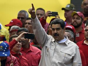 Venezuela's President Nicolas Maduro waves at supporters during a rally at the Miraflores Palace in Caracas, Venezuela (AFP)
