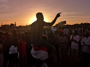 Sudanese protesters rally in the area of the military headquarters in the capital Khartoum at sunset  (AFP)
