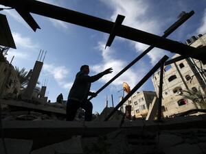 A Palestinian man checks the damaged to a structure hit by Israeli air strikes on Rafah in the southern Gaza strip  (AFP)