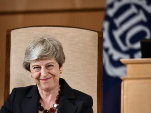 Britain's outgoing Prime Minister Theresa May smiles after delivering her speech at the ILO International Labour Conference on June 11, 2019 in Geneva.  FABRICE COFFRINI / AFP