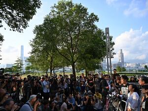 Civil Human Rights Front (CHRF) member Jimmy Sham (R) reacts during a press conference in Hong Kong on June 15, 2019 after Hong Kong Chief Executive Carrie Lam suspended a hugely divisive bill that would allow extraditions to China in a major climbdown after a week of unprecedented protests and political unrest.  HECTOR RETAMAL / AFP