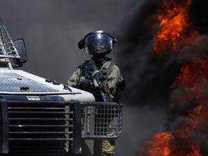A member of the Israeli forces looks on during clashes with Palestinian protesters (AFP)