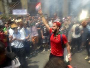 Algerian demonstrators shout slogans as they take part in a protest in the capital Algiers (AFP)
