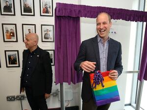 Britain's Prince William, Duke of Cambridge, reacts to receiving a gift bag from trust chief executive officer Tim Sigsworth during a visit to the Albert Kennedy Trust in London to learn about the issue of LGBTQ youth homelessness in London on June 26, 2019.  Jonathan Brady / POOL / AFP