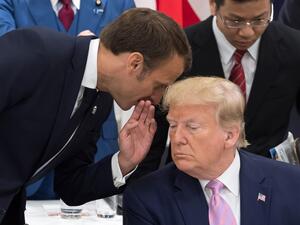 France's President Emmanuel Macron (L) speaks to US President Donald Trump as they attend a meeting on the digital economy at the G20 Summit in Osaka on June 28, 2019.  Jacques Witt / POOL / AFP