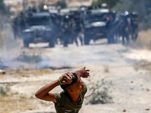 A Palestinian protester prepares to throw a stone at Israeli forces during clashes following a rally against the occupation in the village of Azmut, in the north of the Israeli-occupied West Bank, on June 28, 2019.  JAAFAR ASHTIYEH / AFP