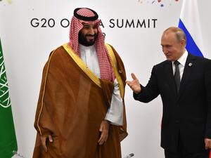 Russia's President Vladimir Putin (R) gestures toward Saudi Arabia's Crown Prince Mohammed bin Salman during a meeting on the sidelines of the G20 Summit in Osaka on June 29, 2019.  Yuri KADOBNOV / POOL / AFP