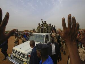 General Abdel Fattah al-Burhan, the head of Sudan's ruling military council, greets his supporters upon his arrival to a rally in Khartoum's twin city of Omdurman (AFP)
