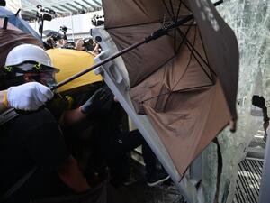 Protesters attempt to enter the government headquarters in Hong Kong  (AFP)