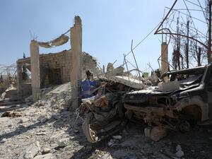 The ruins of a building and the wreckage of a vehicle lie  (AFP)