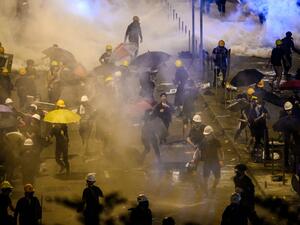 Police fire tear gas at protesters near the government headquarters in Hong Kong  (AFP)