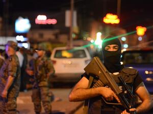 Tunisian security forces tighten security measures outside a metro station near the bus stop where a man reportedly wearing an explosive belt blew himself up in the early hours (AFP)