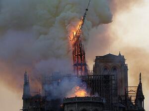Onlookers cried out in anguish as the spire of the cathedral toppled in the inferno which swept ferociously over the roof of Notre Dame on Monday evening (AFP)