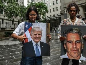 Protesters hold up portraits of Jeffrey Epstein and President Donald Trump in front of the Federal courthouse in New York City, the US, on July 8, 2019 ( AFP)