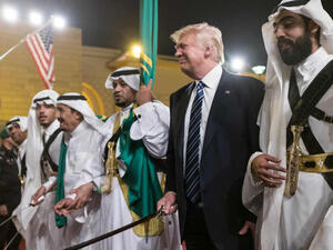 U.S. President Donald Trump brandishes a sword during a welcome ceremony in Riyadh, Saudi Arabia on May 20, 2017 /AFP