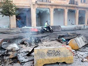 A Lebanese motorist drives past debris at Riad Al Solh Square in the centre of the capital Beirut. Anwar Amro/AFP
