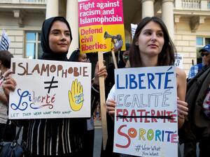 Women join a demonstration organised by "Stand up to Racism" outside the French Embassy in London on 26 August, 2016 /AFP