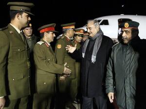 Khalifa Haftar, second from right, the military leader of the so-called Libyan National Army, is greeted after a trip to Russia /AFP