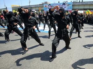 Iraqi Shiite fighters from the Iran-backed Hezbollah brigades take part in a military parade to mark the pro-Palestinian Al-Quds (Jerusalem) Day in Baghdad, May 2020 /AFP
