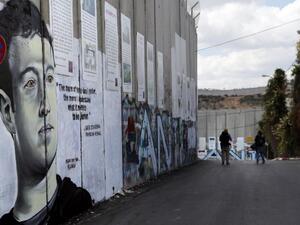 Graffiti depicting Mark Zuckerberg, founder of Facebook, on the Israeli separation barrier /AFP