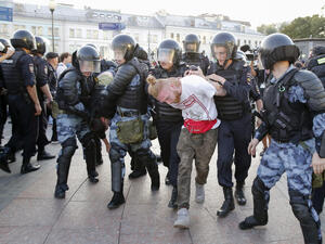 Riot police officers detain protesters during an unauthorised rally demanding independent and opposition candidates be allowed to run for office in local election in September (AFP)