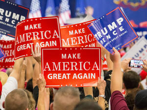Manheim, PA - October 1, 2016: People enthusiastically wave Make America Great Again Signs at a Donald Trump campaign rally.