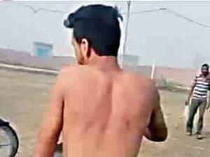Man stripped naked and forced to ride a motorbike for sexually harassing a woman in India. 